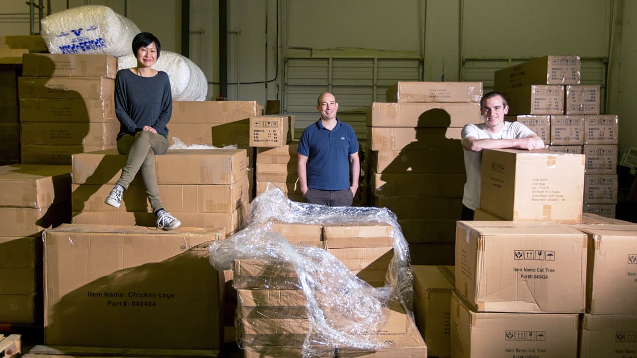 People sitting and standing around boxes