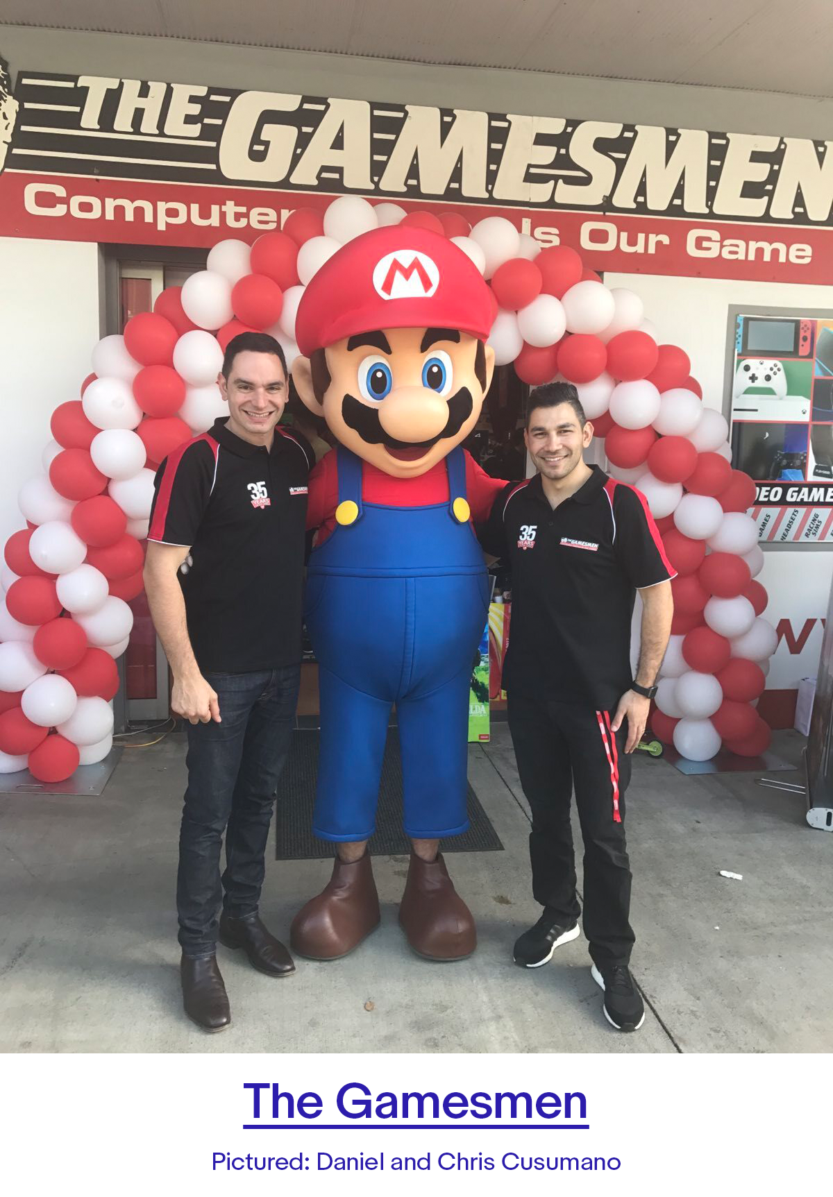 Workers posing with Mario in front of the Gamesmen