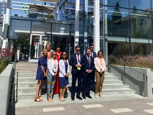 eBay's Marie Huber and Cathy Foster welcome the delegation in front of eBay's Main Street Building