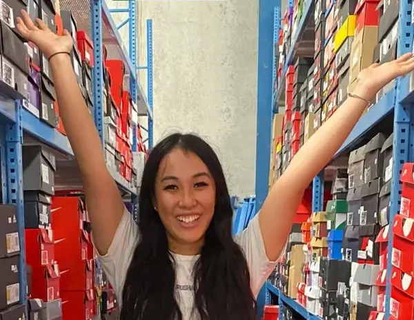 Excited girl selling sneakers