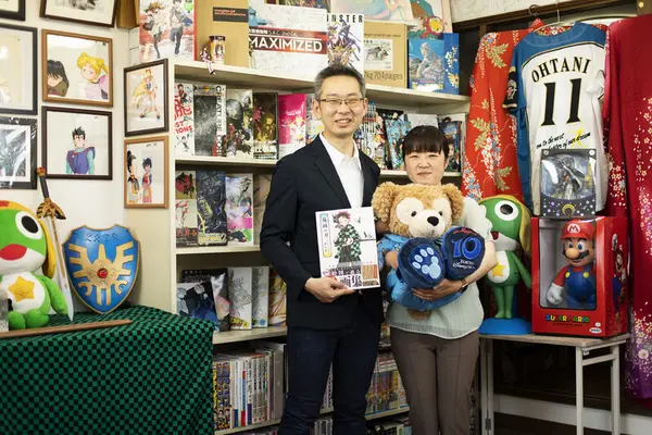 eBay sellers holding book and stuffed bear